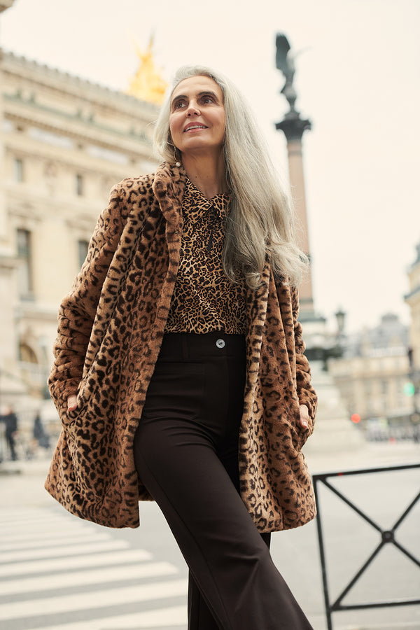 Woman in Leopard Print Faux Fur Coat with Leopard print shirt and brown Wide Leg Pants