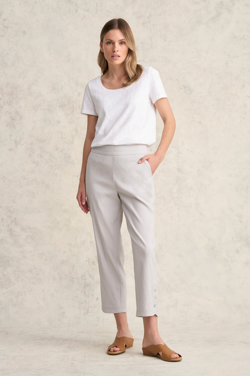 A blue ankle length cotton linen pant with plain belt in front